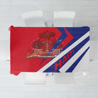 Red tablecloth with blue diagonal stripes and Haiti 1804 coat of arms print