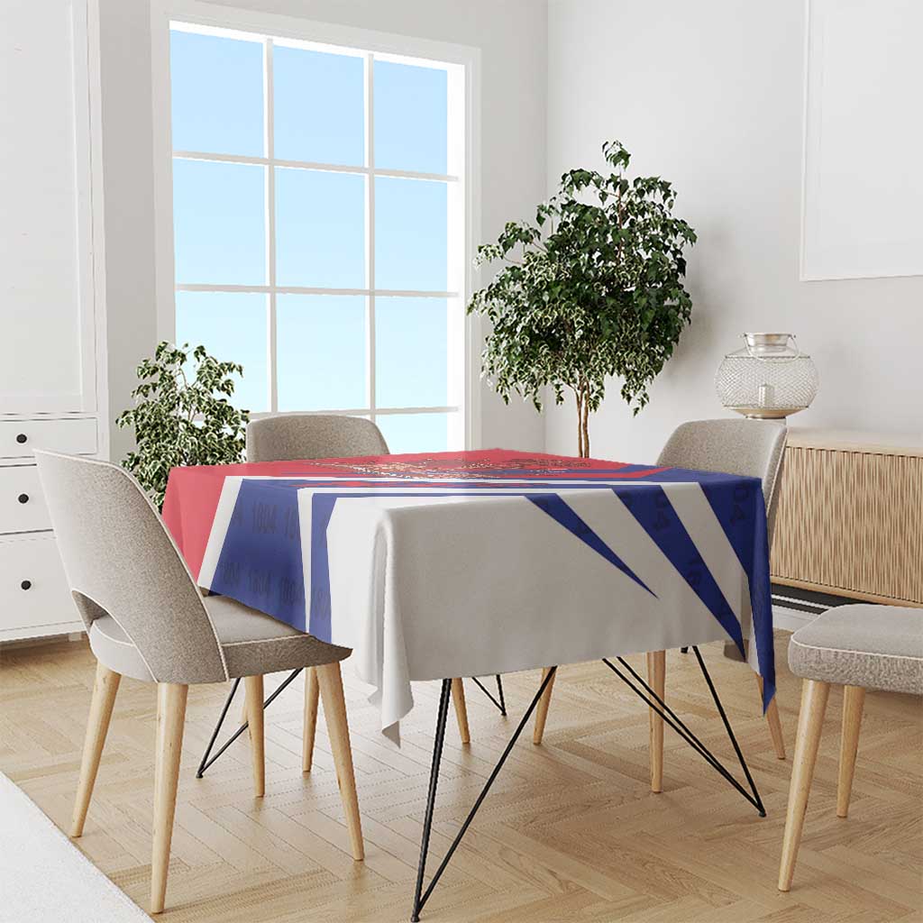 Red and blue tablecloth with diagonal stripe pattern, draped over dining table