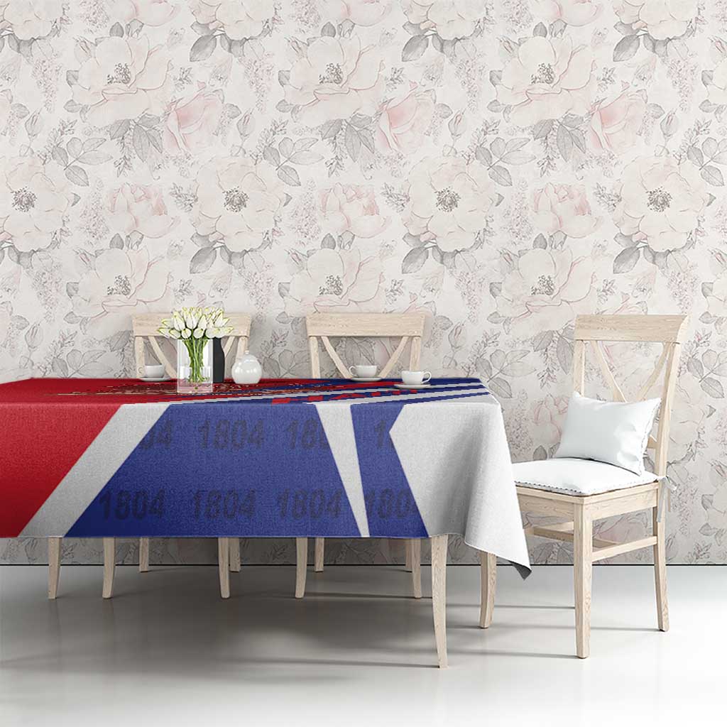 Red and blue tablecloth with Haiti 1804 lettering and coat of arms, draped on table