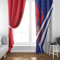 Red and blue window curtains with diagonal stripe design and coat of arms emblem