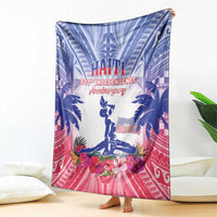 Folding Haiti independence blanket in blue and pink with palm trees, flowers, and statue
