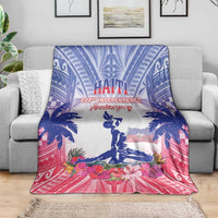 Haiti independence blanket draped over gray sofa in blue, white, and pink with flowers