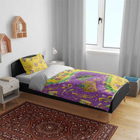 Mardi Gras glitter bedding set on a bed: purple and gold comforter with decorative mask and pillow