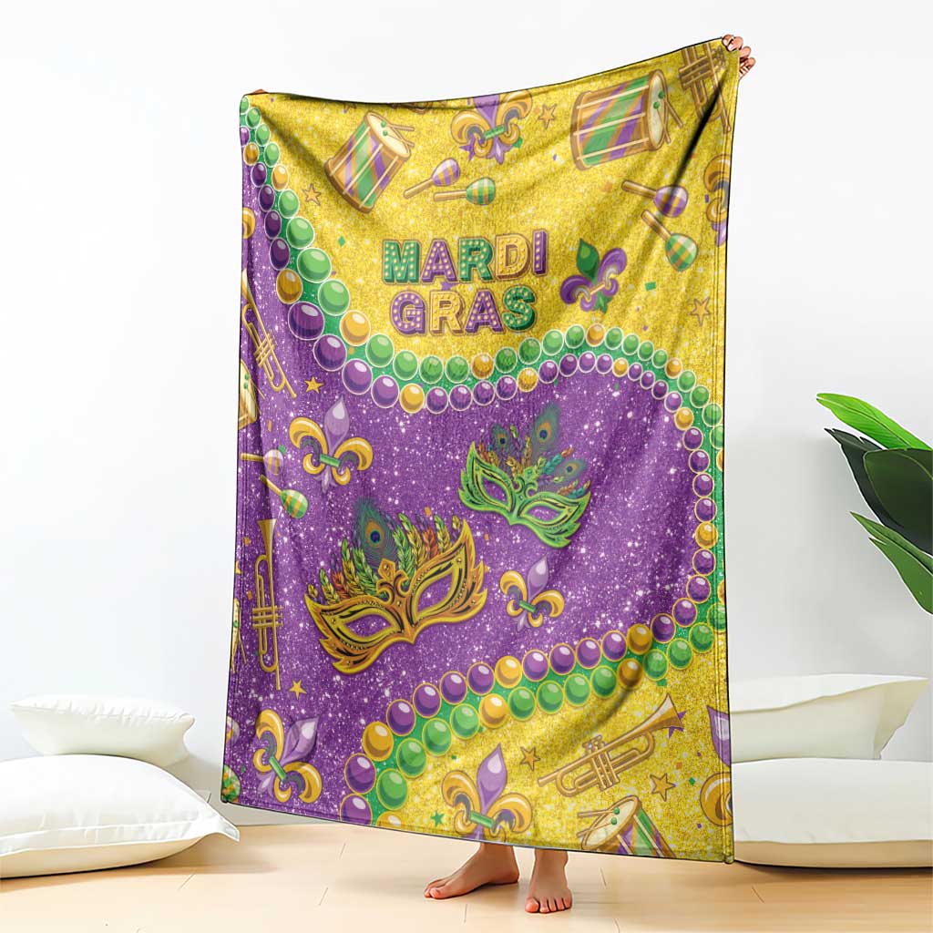 Purple and gold Mardi Gras glitter blanket with fleur-de-lis masks, beads, and musical symbols