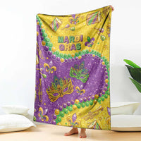 Purple and gold Mardi Gras glitter blanket with fleur-de-lis masks, beads, and musical symbols