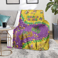 Mardi Gras glitter style blanket in purple and gold with fleur-de-lis masks and beads