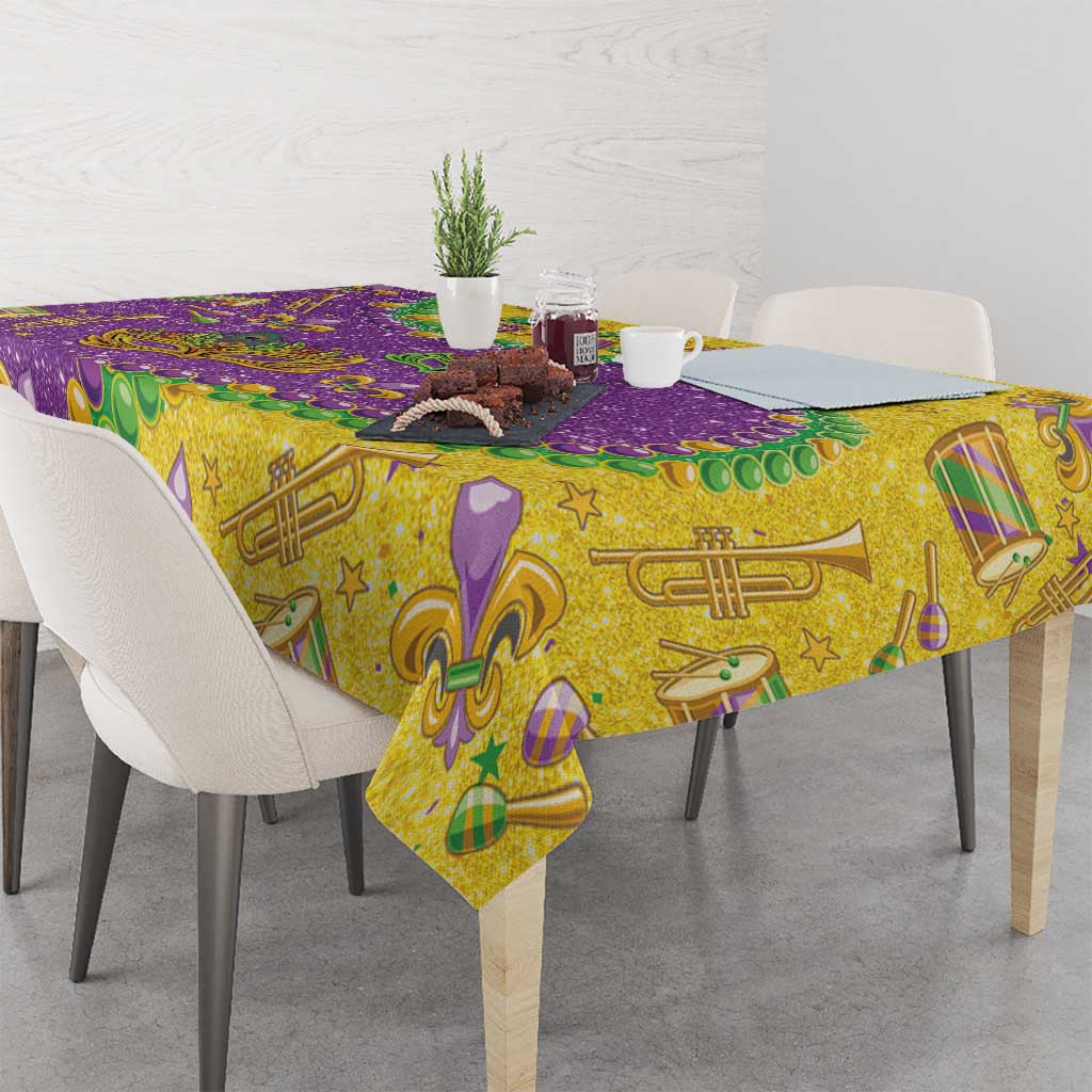 Glitter Mardi Gras tablecloth with gold, purple, and green music and masks pattern.