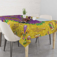 Glitter Mardi Gras tablecloth with gold, purple, and green music and masks pattern.