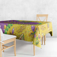 Glitter Mardi Gras tablecloth, gold base with purple border and green decorative icons.
