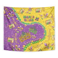 Close-up glitter tapestry: purple and gold with green masks, beads, and fleur-de-lis decorations
