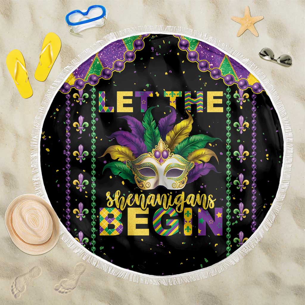 Round black beach blanket with Mardi Gras fleur-de-lis beads, gold mask and white fringe