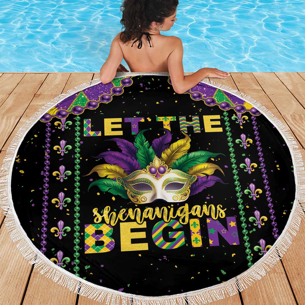 Round black beach blanket with Mardi Gras mask, green-and-gold text, and white fringe border