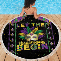 Round black beach blanket with Mardi Gras mask, green-and-gold text, and white fringe border