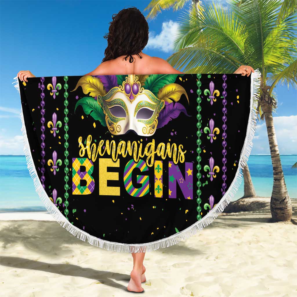 Round black Mardi Gras beach blanket with fleur-de-lis bead garland, mask artwork, white fringe