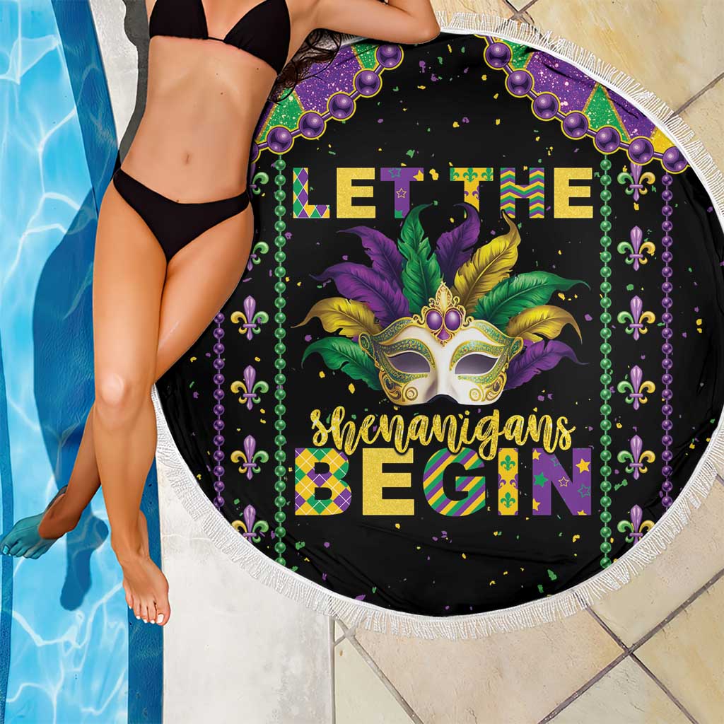 Round black beach blanket featuring Mardi Gras mask, purple bead border, and white fringe trim