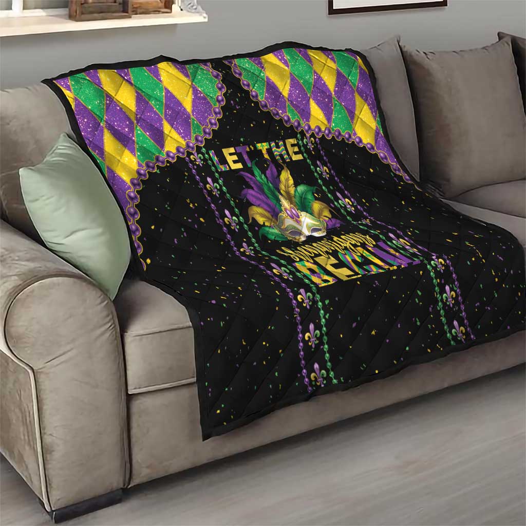Black Mardi Gras quilt draped on couch with purple fleur-de-lis art and diamond frame