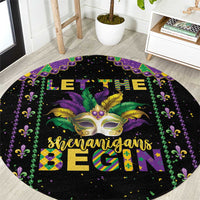 Close-up view of black round Mardi Gras carpet with gold mask and green-purple trim