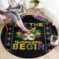 Black round Mardi Gras carpet with colorful lettering, mask, and fleur-de-lis border