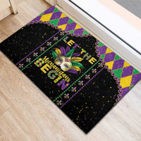Black Mardi Gras rubber doormat with fleur-de-lis mask and 'Let the' headline in purple