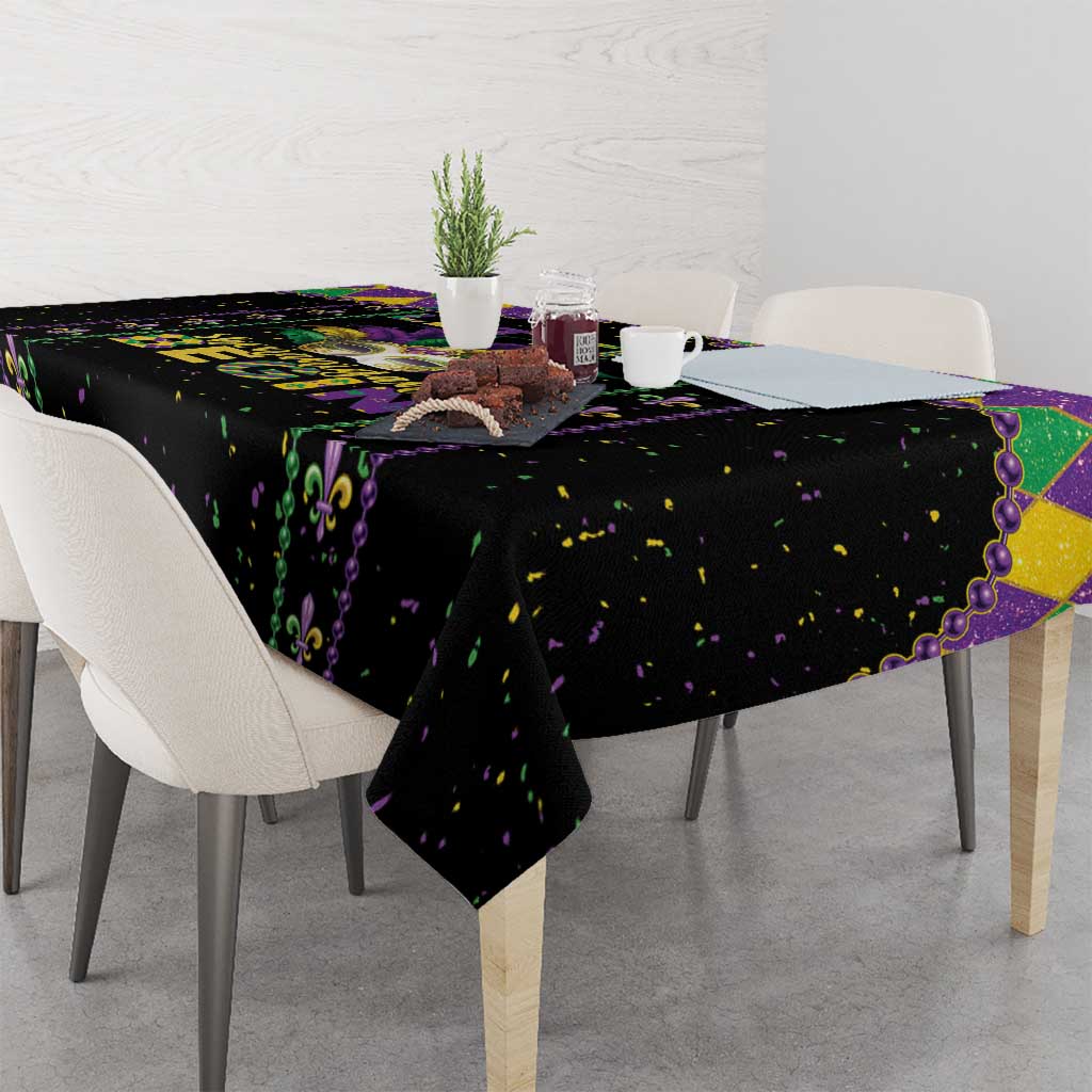 Black party tablecloth with purple and green fleur-de-lis and confetti print