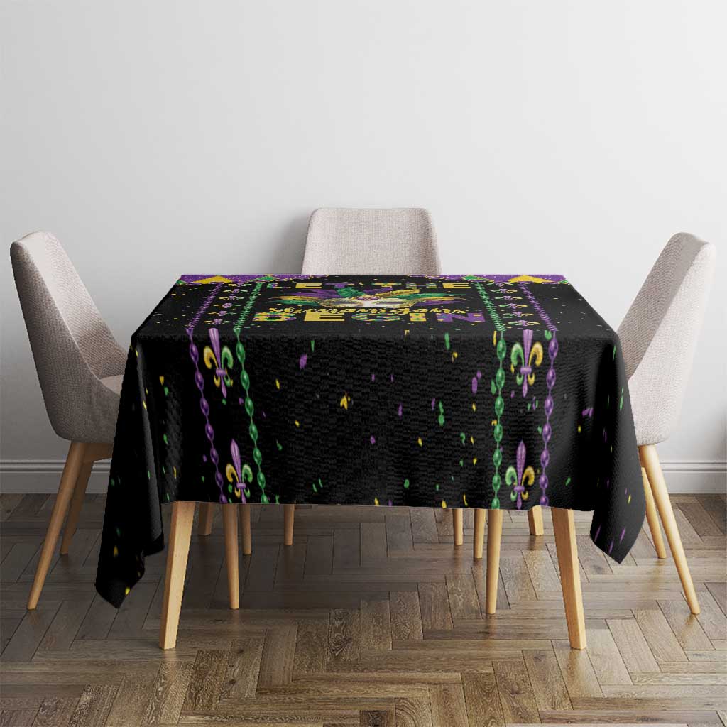 Black square tablecloth with colorful fleur-de-lis stripe and confetti speckles