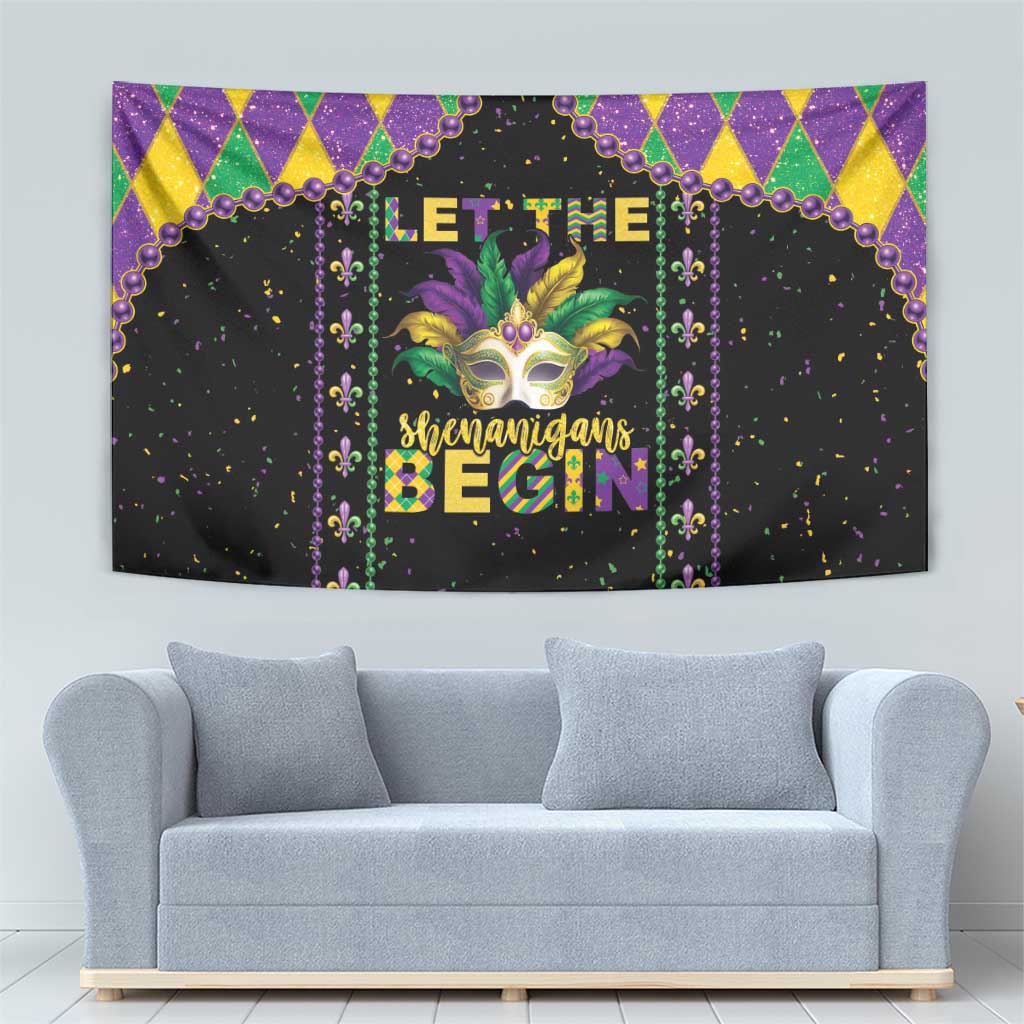 Black Mardi Gras tapestry with colorful harlequin border, gold mask graphic, and dangling bead lines.