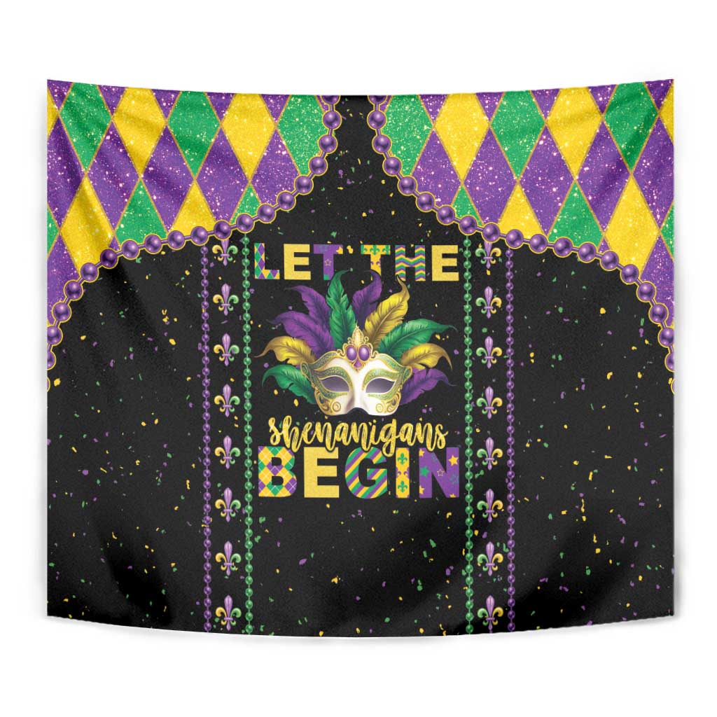 Black Mardi Gras tapestry with harlequin top border, purple beads, and masked jester face center.