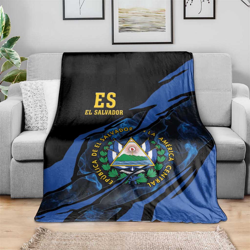 Black and blue El Salvador blanket with coat-of-arms triangle emblem on sofa