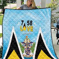 Light blue quilt blanket with “7 58” L•VE and Saint Lucia crest design, diamond stitching