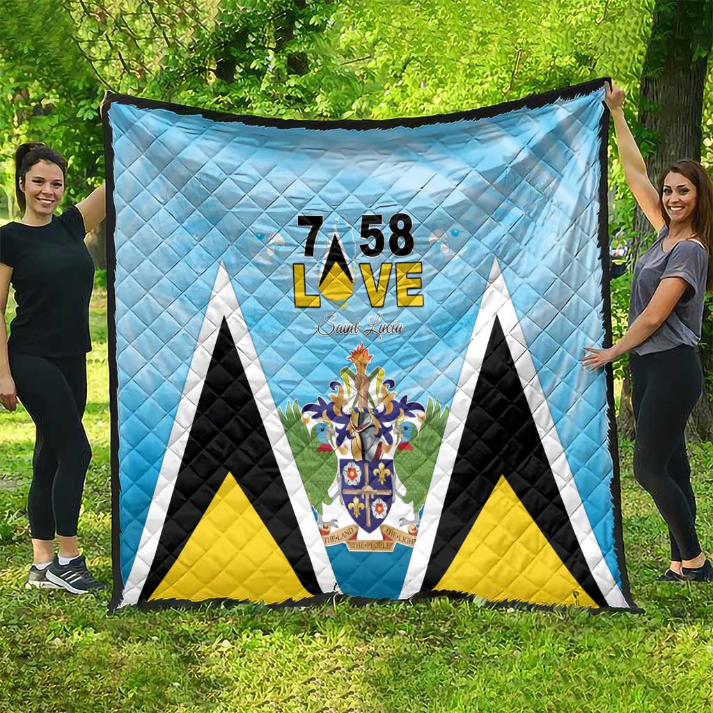Light blue quilt blanket with 7 58 L•VE text and Saint Lucia coat of arms motif