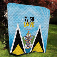 Light blue quilt blanket featuring “7 58 L•VE” and central Saint Lucia crest emblem