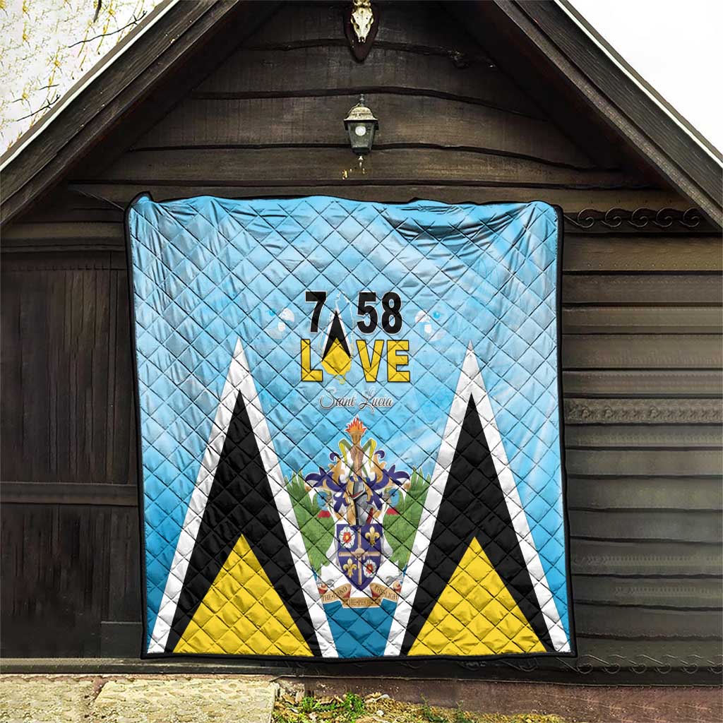 Light blue quilt blanket with diamond quilting and “7 58 L•VE” Saint Lucia crest center
