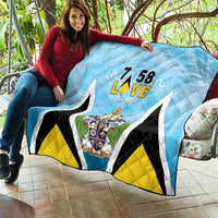 Light blue quilt blanket with “7 58 L•VE” text, Saint Lucia crest, and bold black trim