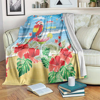 Blue tropical Christmas blanket with macaw, hibiscus blooms, and beachy quote
