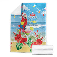 Blue tropical Christmas blanket folded with macaw, red hibiscus, and beachy quote
