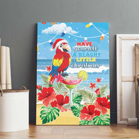 Blue canvas wall art with macaw parrot wearing Santa hat, surrounded by tropical leaves and blooms