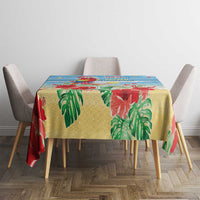 Blue tropical Christmas tablecloth with red bird, green leaves, and bright festive pattern