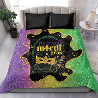 Mardi Gras theme bedding set showing purple/green glitter duvet with black speckled pillowcases