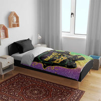 Mardi Gras bedding set with black speckled pillows and purple-green duvet with gold mask artwork