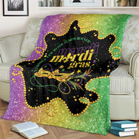 Colorful Mardi Gras blanket on cream couch, purple-green gradient with gold mask artwork
