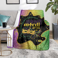 Colorful Mardi Gras blanket over sofa arm, glitter purple-to-green with gold Mardi Gras mask