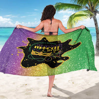 Mardi Gras glitter sarong draped in green and purple with central Mardi Gras logo