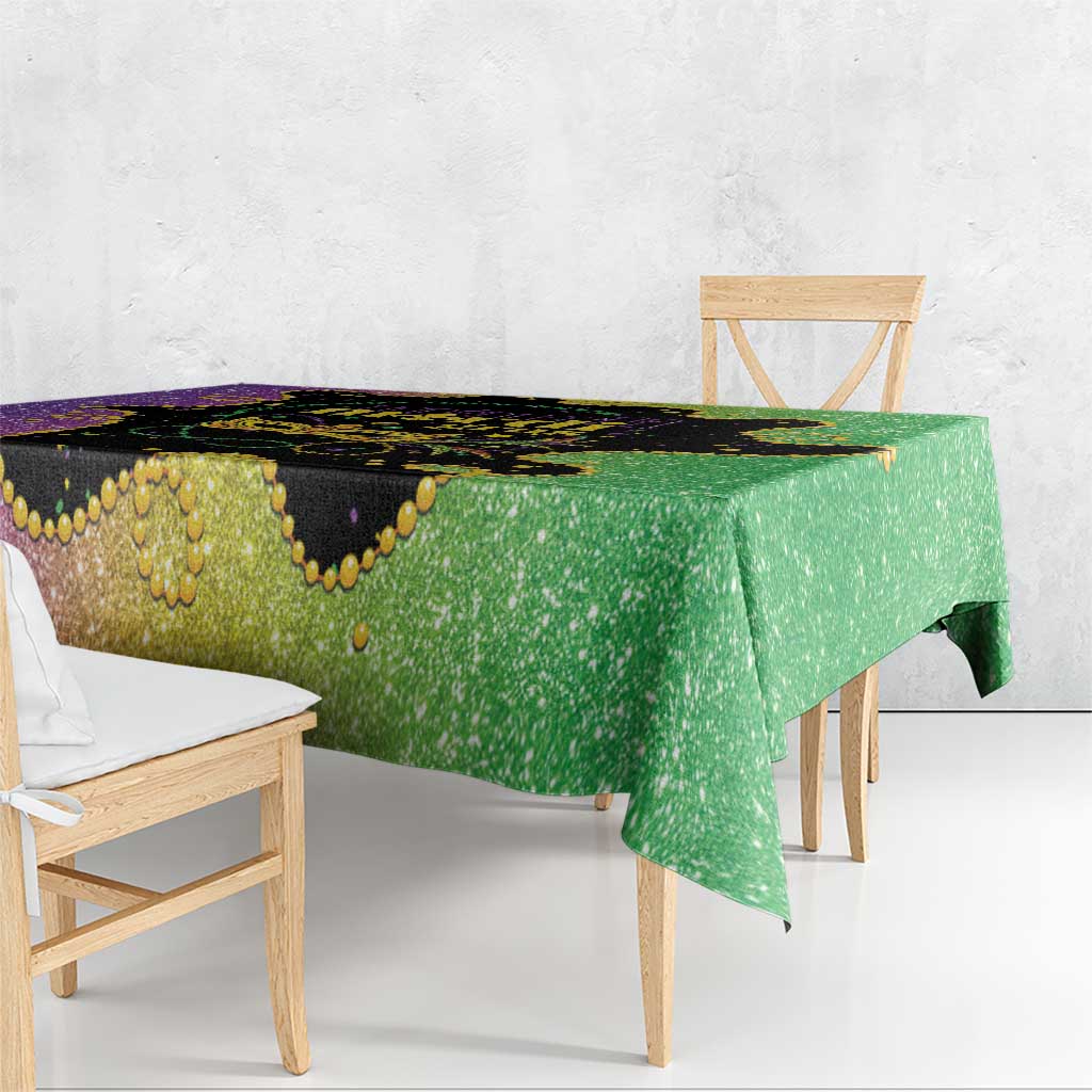 Mardi Gras tablecloth corner view with black center, purple border, and green hanging edge