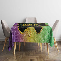 Mardi Gras tablecloth over square table with purple and green glitter print and black center