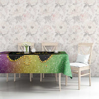 Dining table Mardi Gras tablecloth with purple and green glitter pattern and gold decorative trim