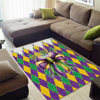 Colorful area rug featuring a purple glitter bow over green, yellow, and purple diamond grid