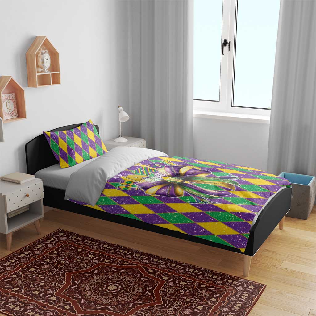 Mardi Gras bedding set on bed with purple, green, yellow diamond pattern and large bow