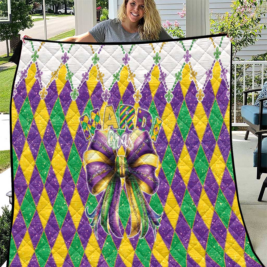 Colorful diamond-pattern quilt with large multicolor bow and fleur-de-lis accents