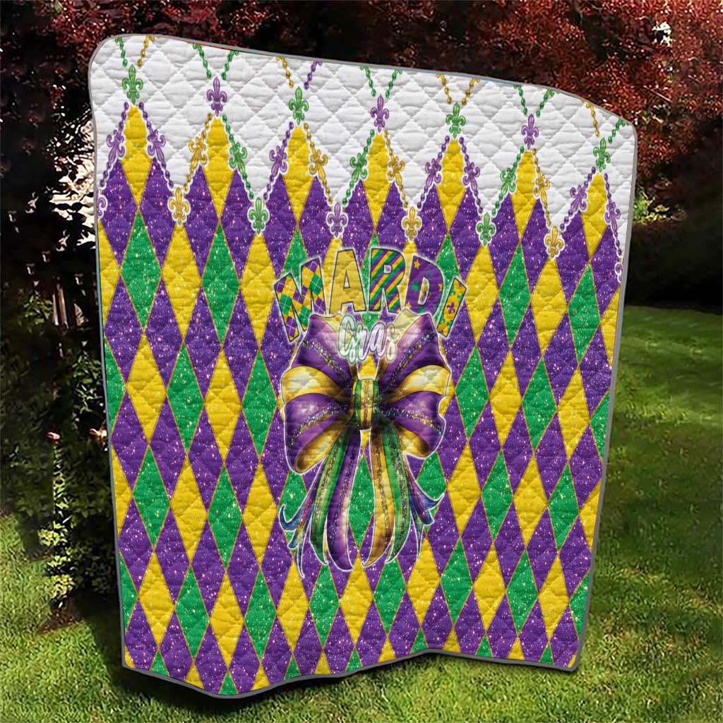 Colorful diamond-pattern quilt with large multicolor bow centerpiece