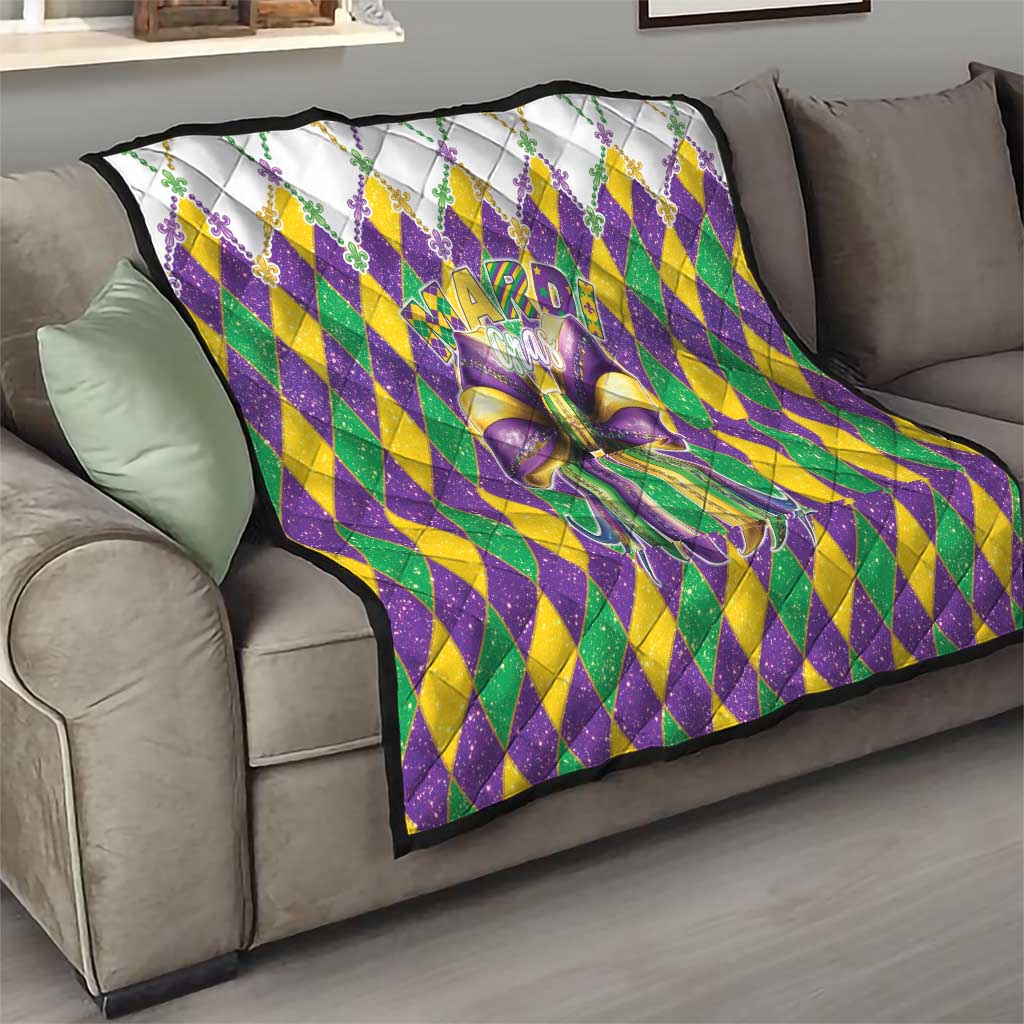 Colorful diamond-pattern quilt with large multicolor bow on a sofa
